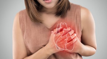 Woman clutching her heart with a diagram of the heart showing heart problems.jpg