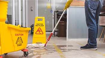floor-being-mopped-with-bucket-on-wheels-and-caution-wet-floor-sign-sml.jpg