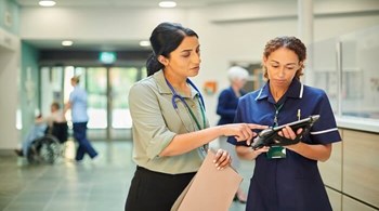 Hospital colleagues checking medical records database.jpg